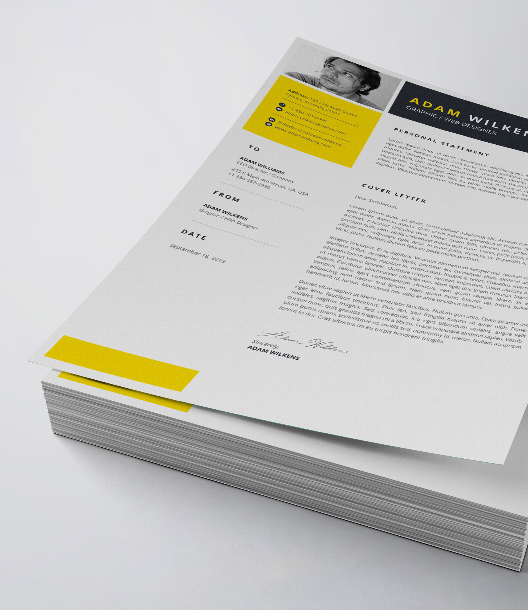 Yellow and black resume on top of a stack of papers.