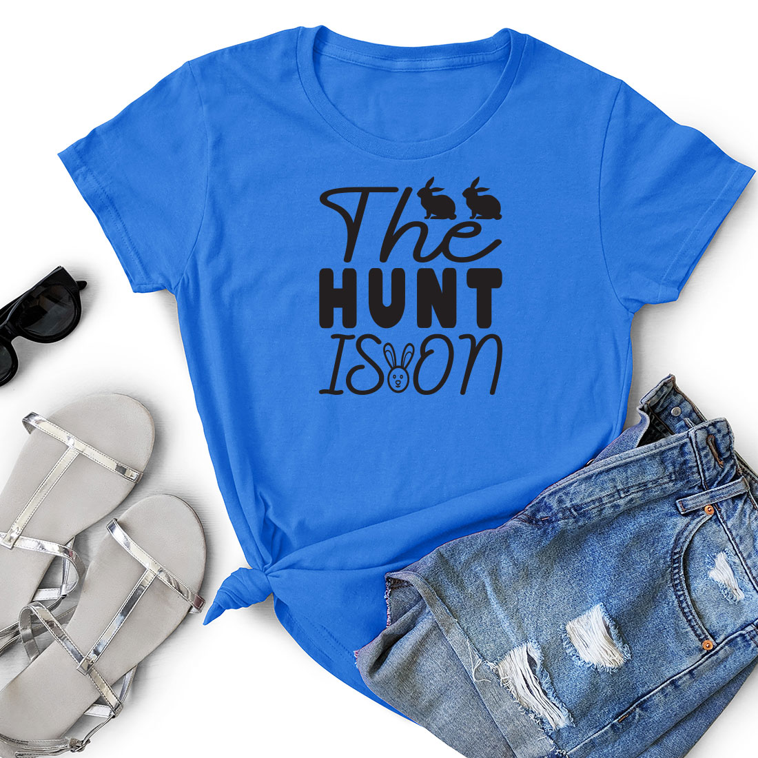 T - shirt that says the hunt is on next to a pair of shorts.