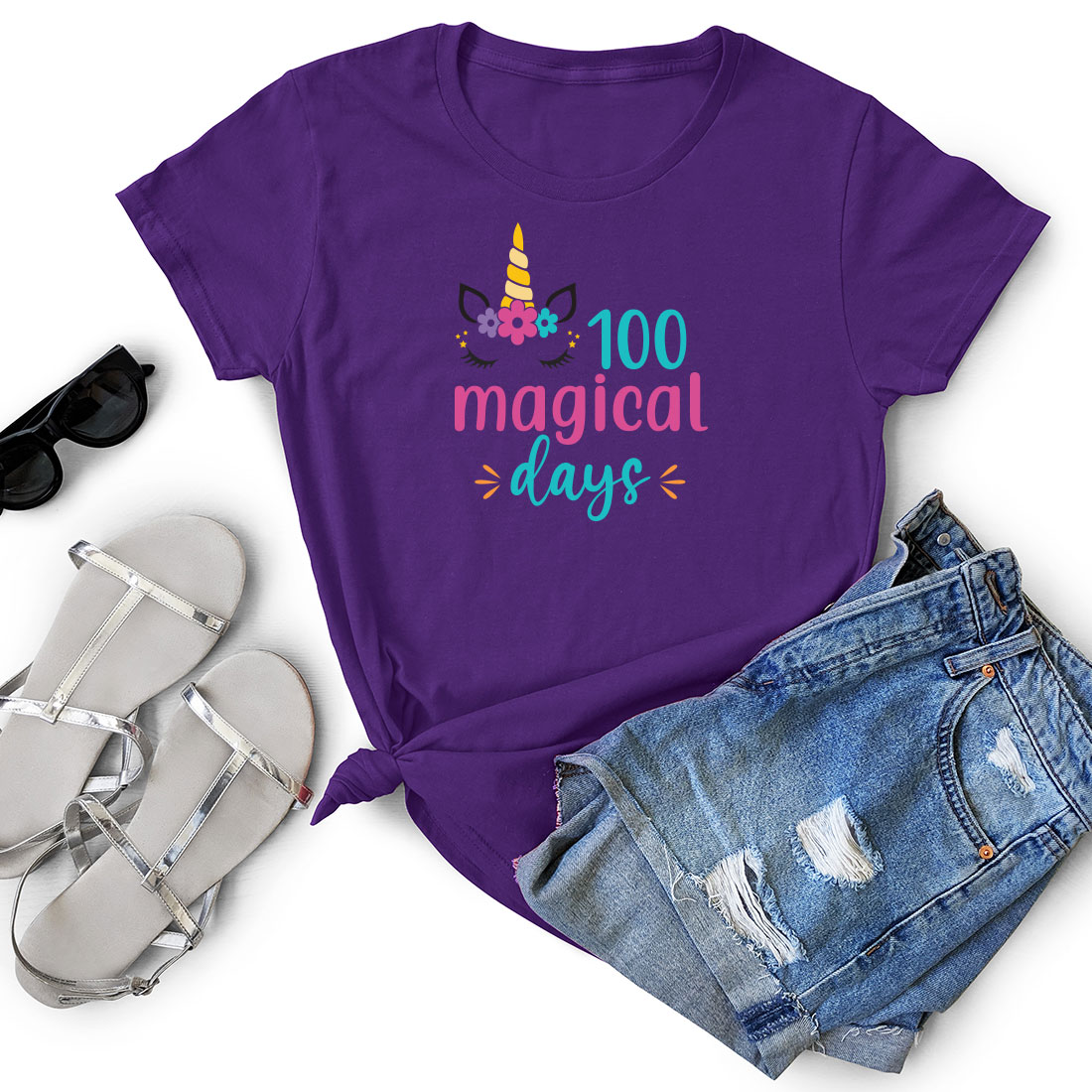 Purple shirt with a unicorn on it and a pair of shorts.