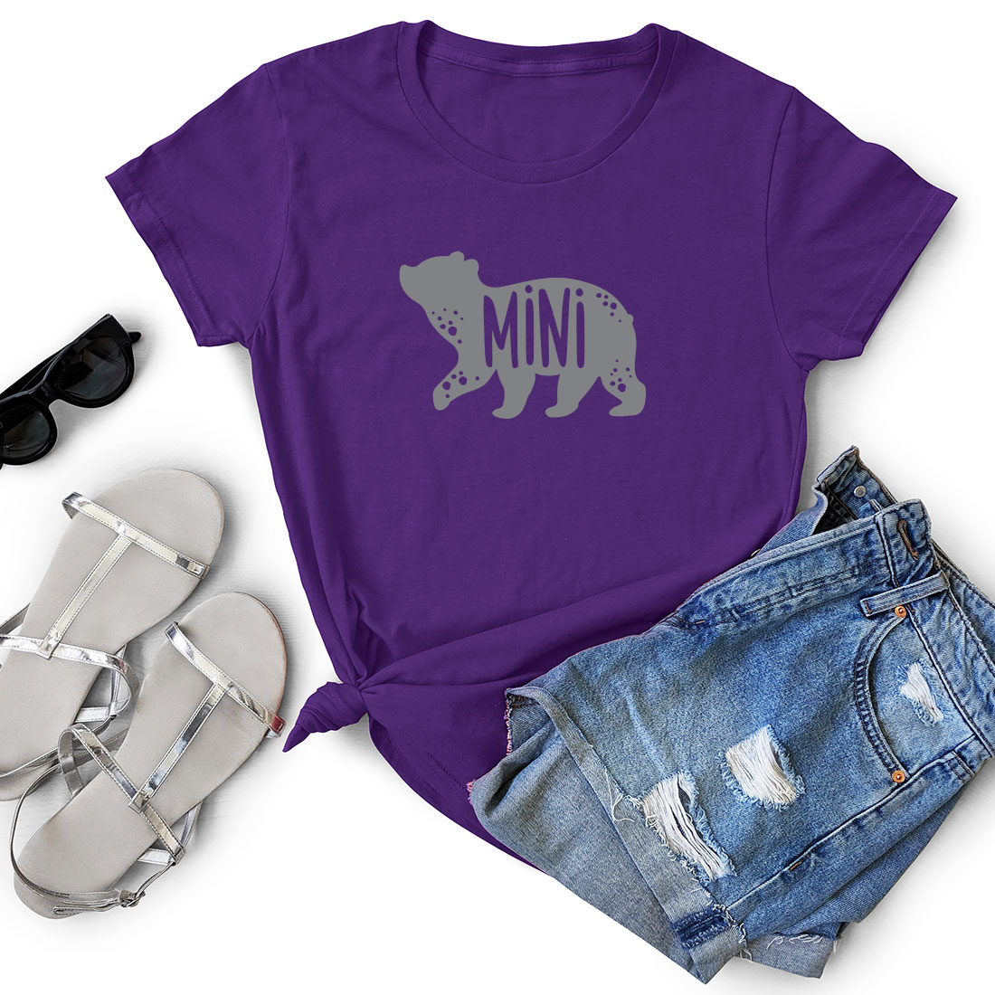 Purple shirt with the word minn on it next to a pair of shorts.