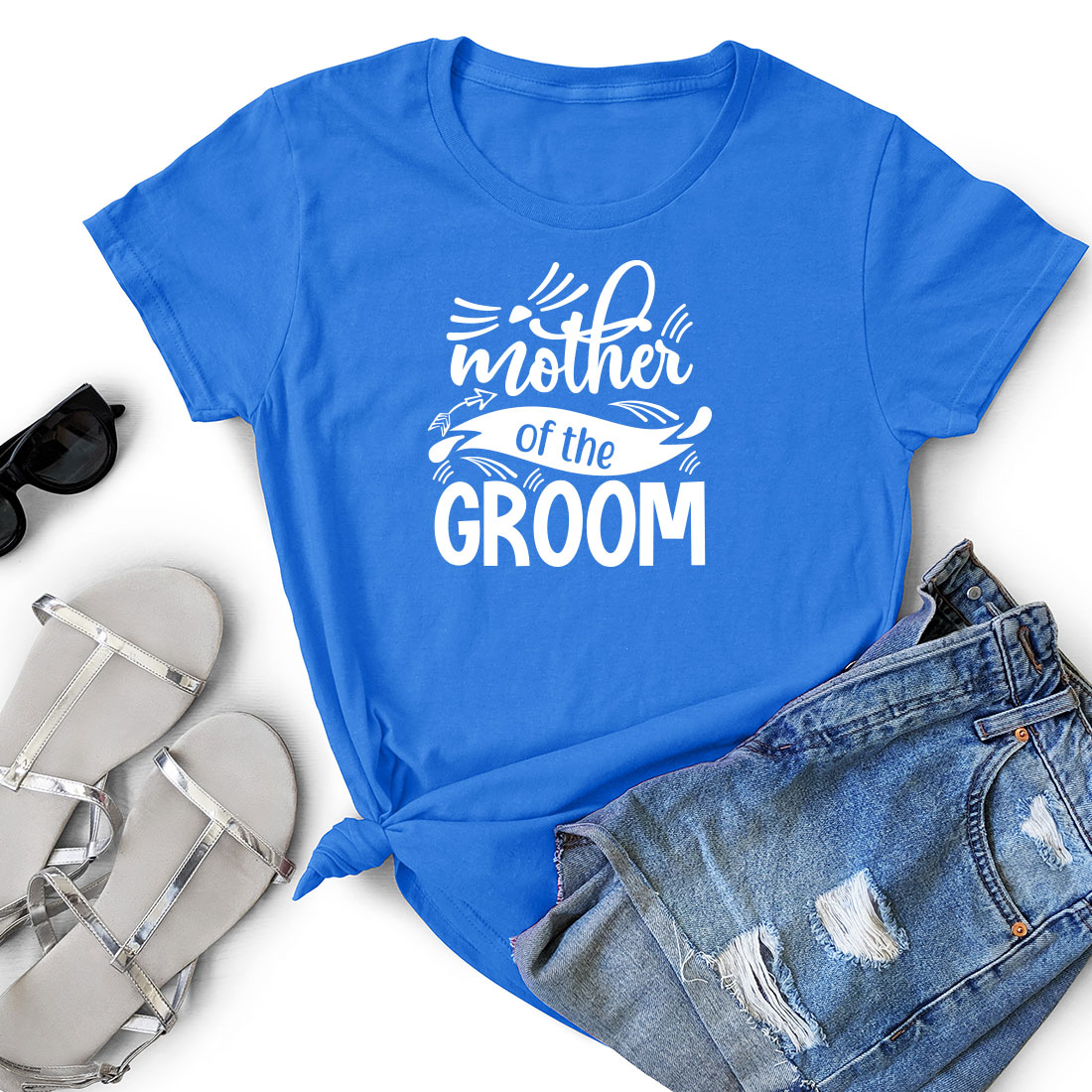 T - shirt that says mother of the groom next to a pair of shorts.