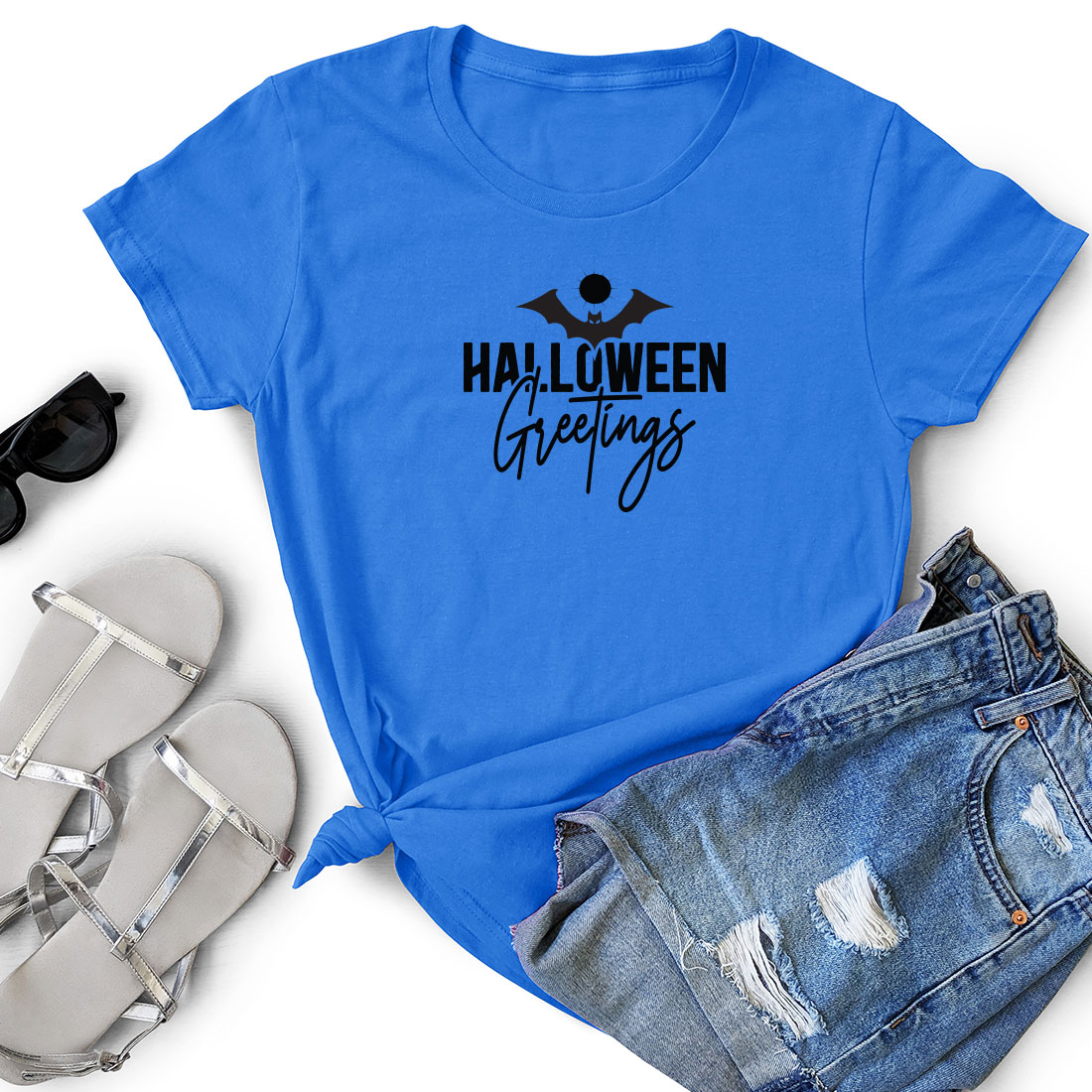 T - shirt that says halloween greetings on it.