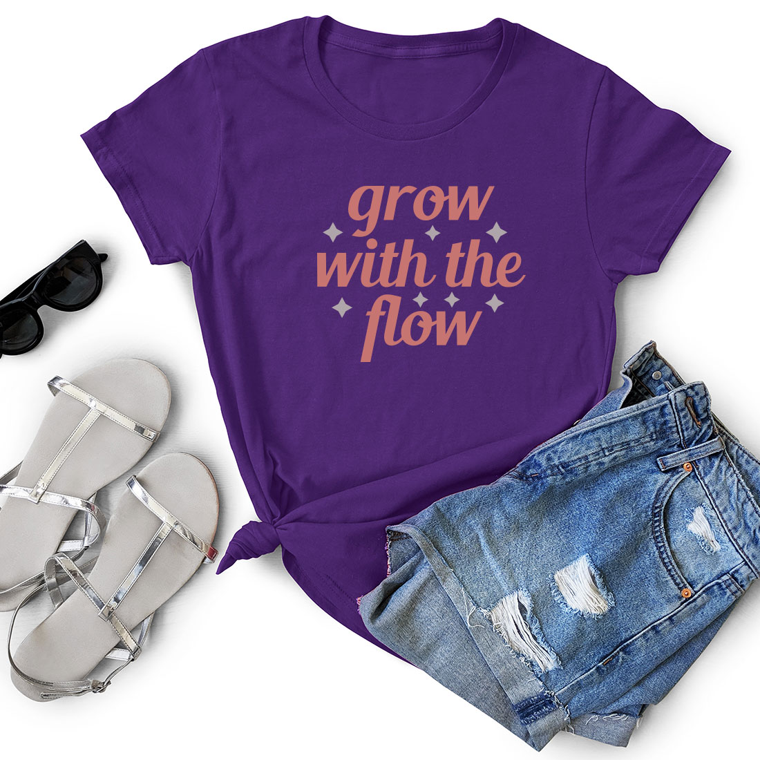 T - shirt that says grow with the flow next to a pair of shorts.