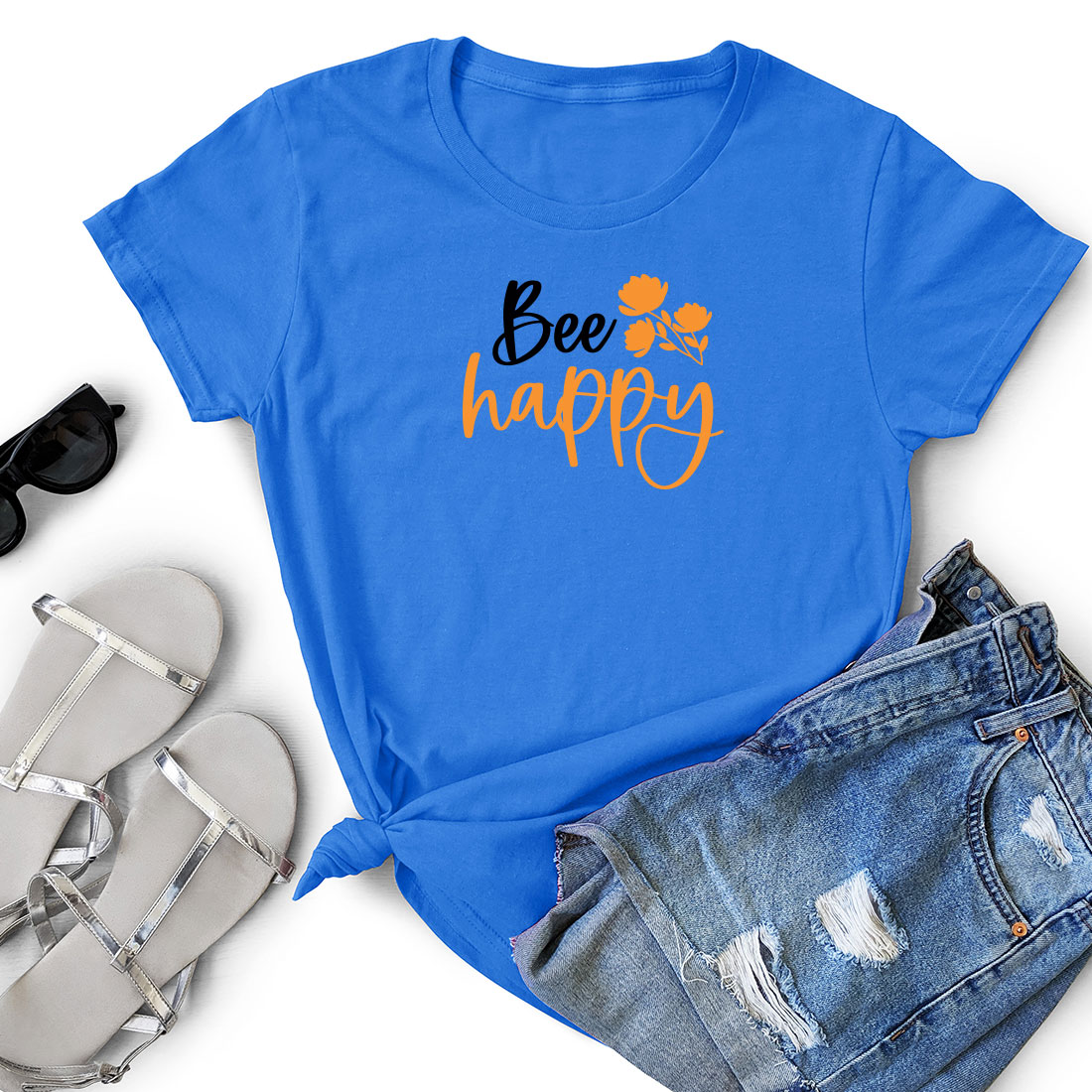 T - shirt that says bee happy next to a pair of shorts.