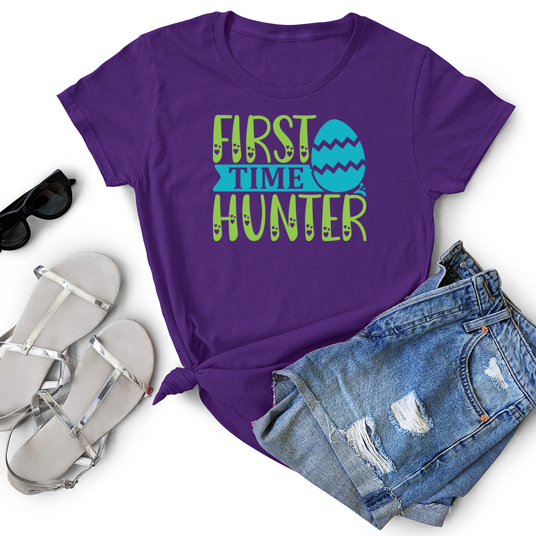 Purple shirt that says first time hunter next to a pair of shorts.