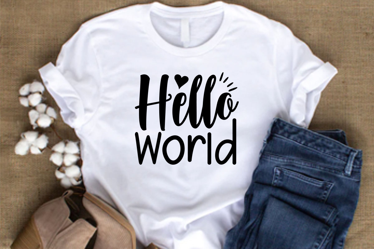 White shirt that says hello world next to a pair of jeans.