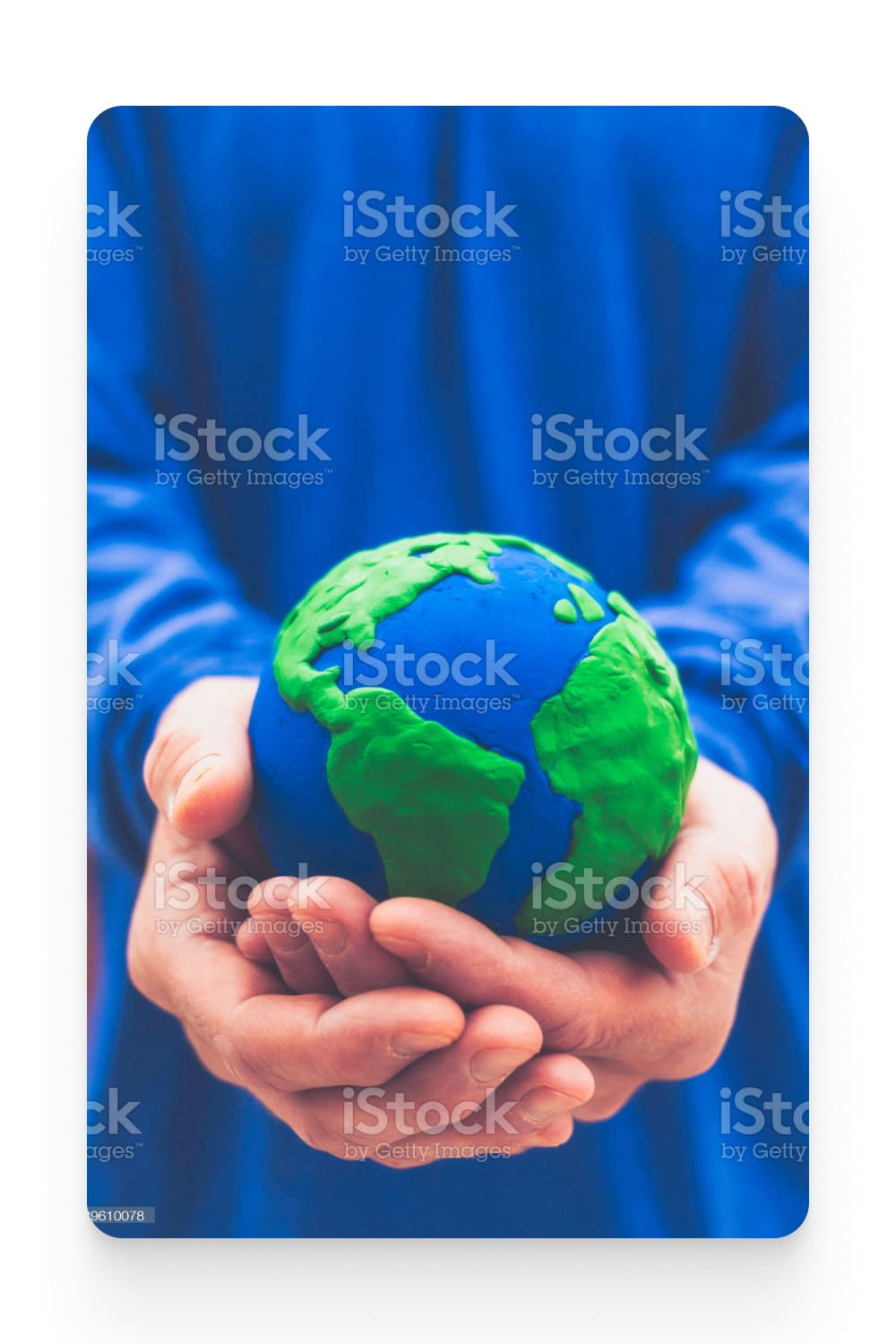 Unidentifiable male holding a handmade world in his hands.