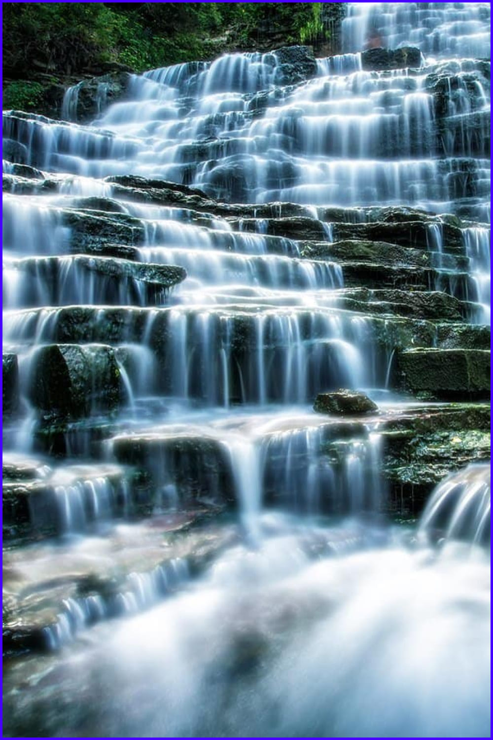 Photo of water flowing over rocks in the forest.