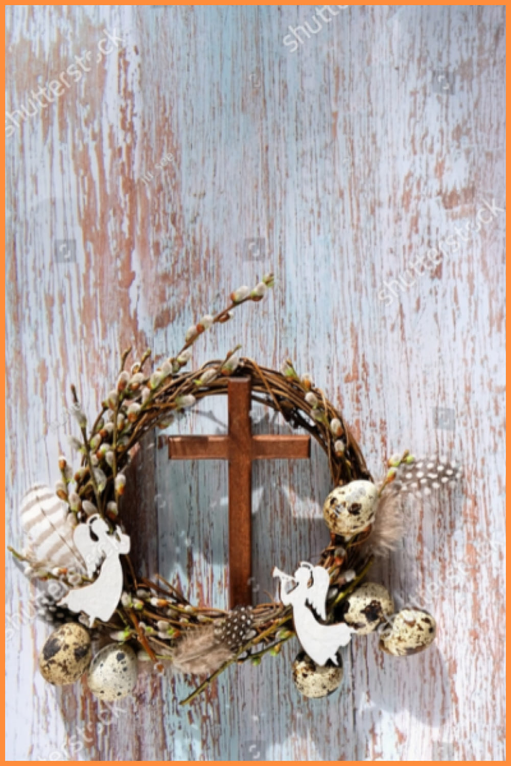 pussy willow wreath, eggs, cross and decorative angels on rustic wooden background.