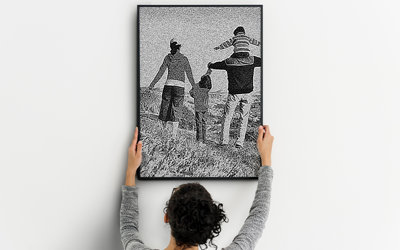 Woman holding up a black and white picture of two people.