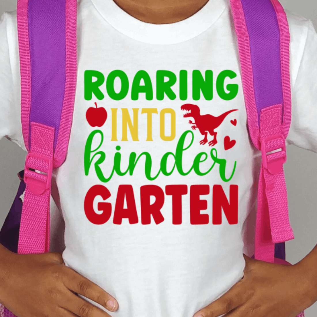 Child wearing a t - shirt that says roar into kinder garter.