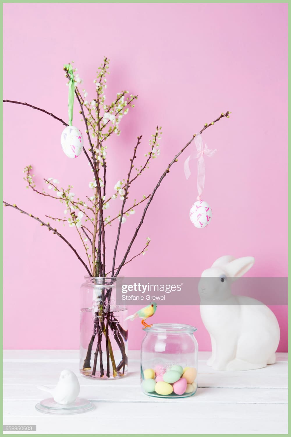 Vase filled with flowers next to an easter decoration.