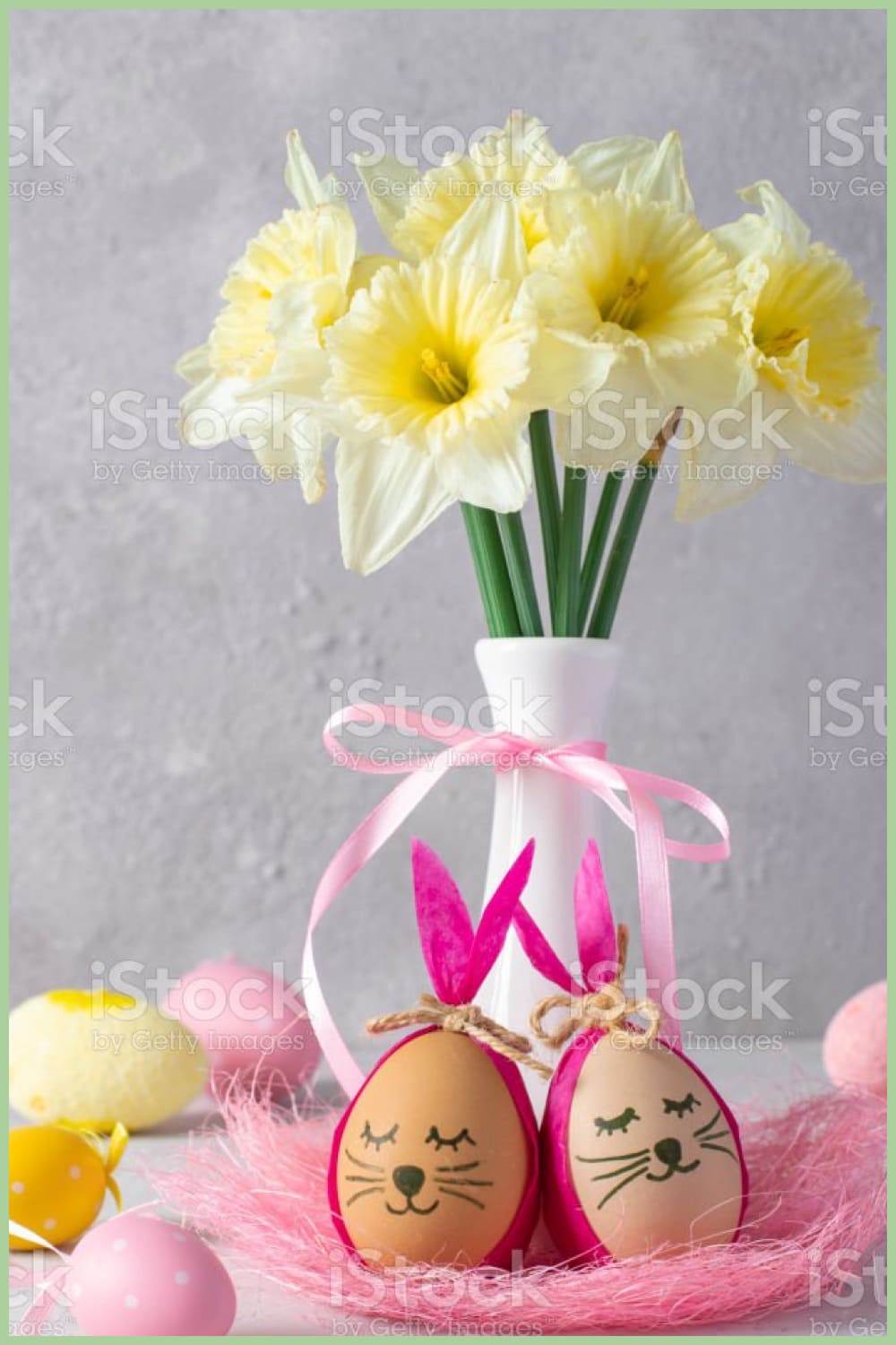 Easter bunnies made of eggs with multi-colored ears made of colored paper or napkins and daffodils in a vase.