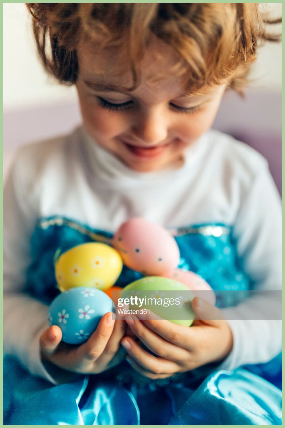 Happy little girl holding Easter eggs.