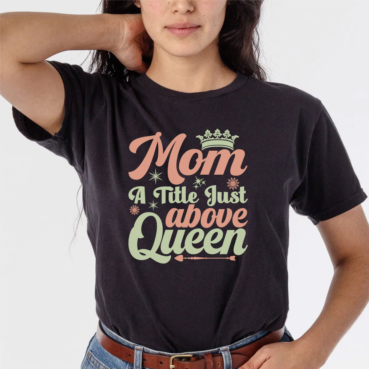 Woman wearing a black shirt with a crown on it.