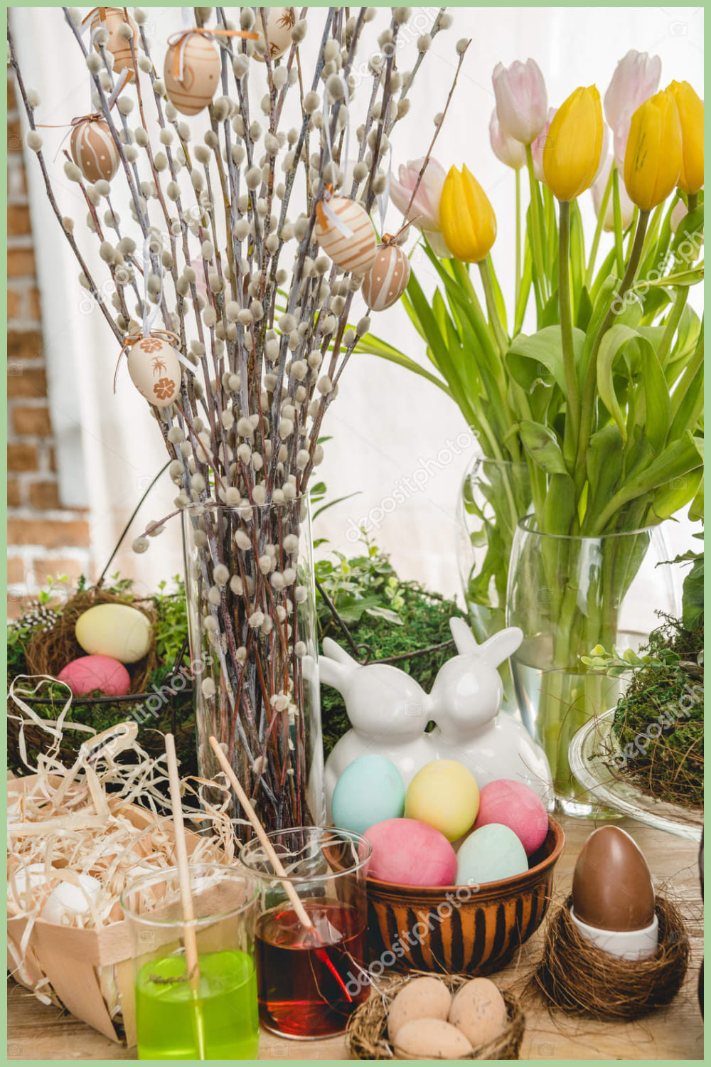 Composition of vases with willows and tulips, Easter eggs and figurines of rabbits.