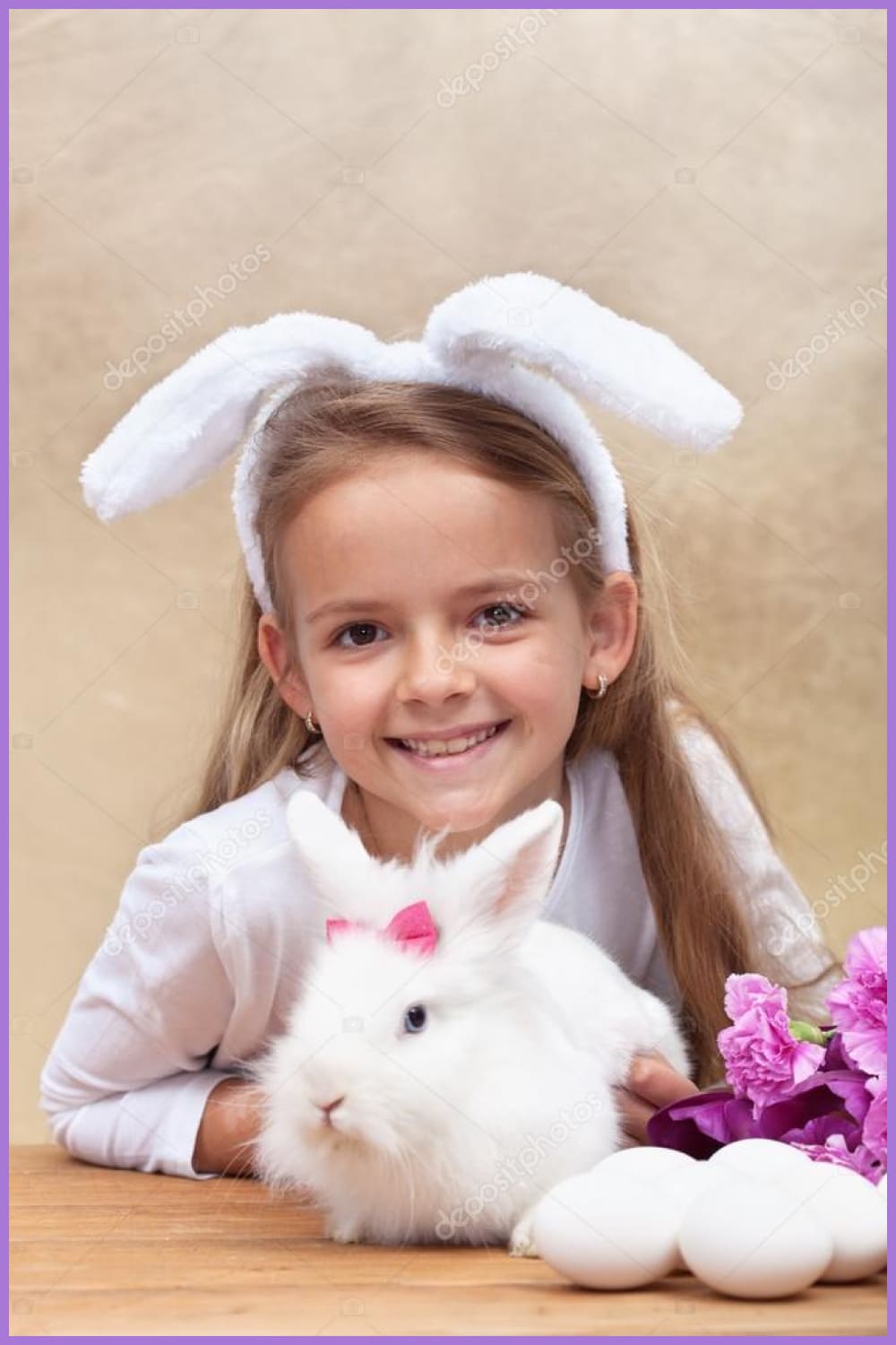 Happy little girl with bunny ears and her cute white rabbit.