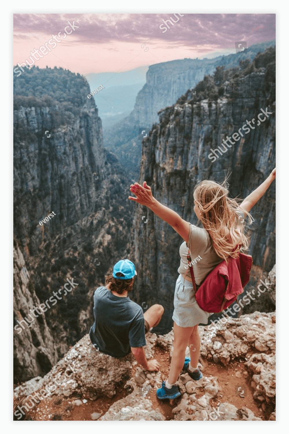 Couple on cliff Tazi canyon travel hiking together healthy lifestyle active summer vacations.