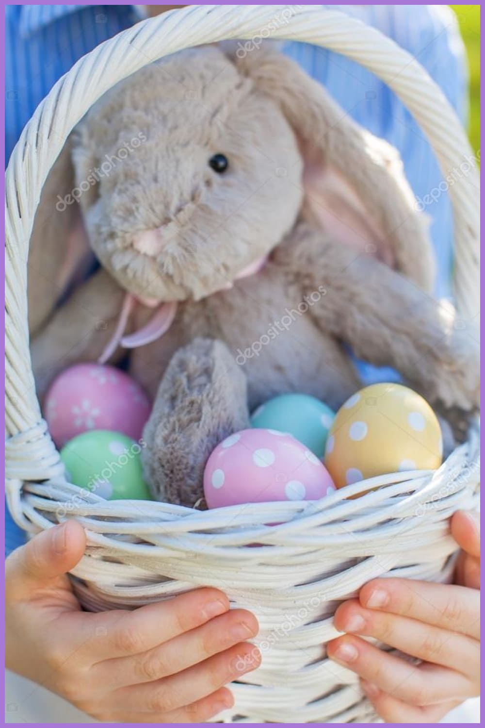 White basket in hands with easter eggs and bunny toy.