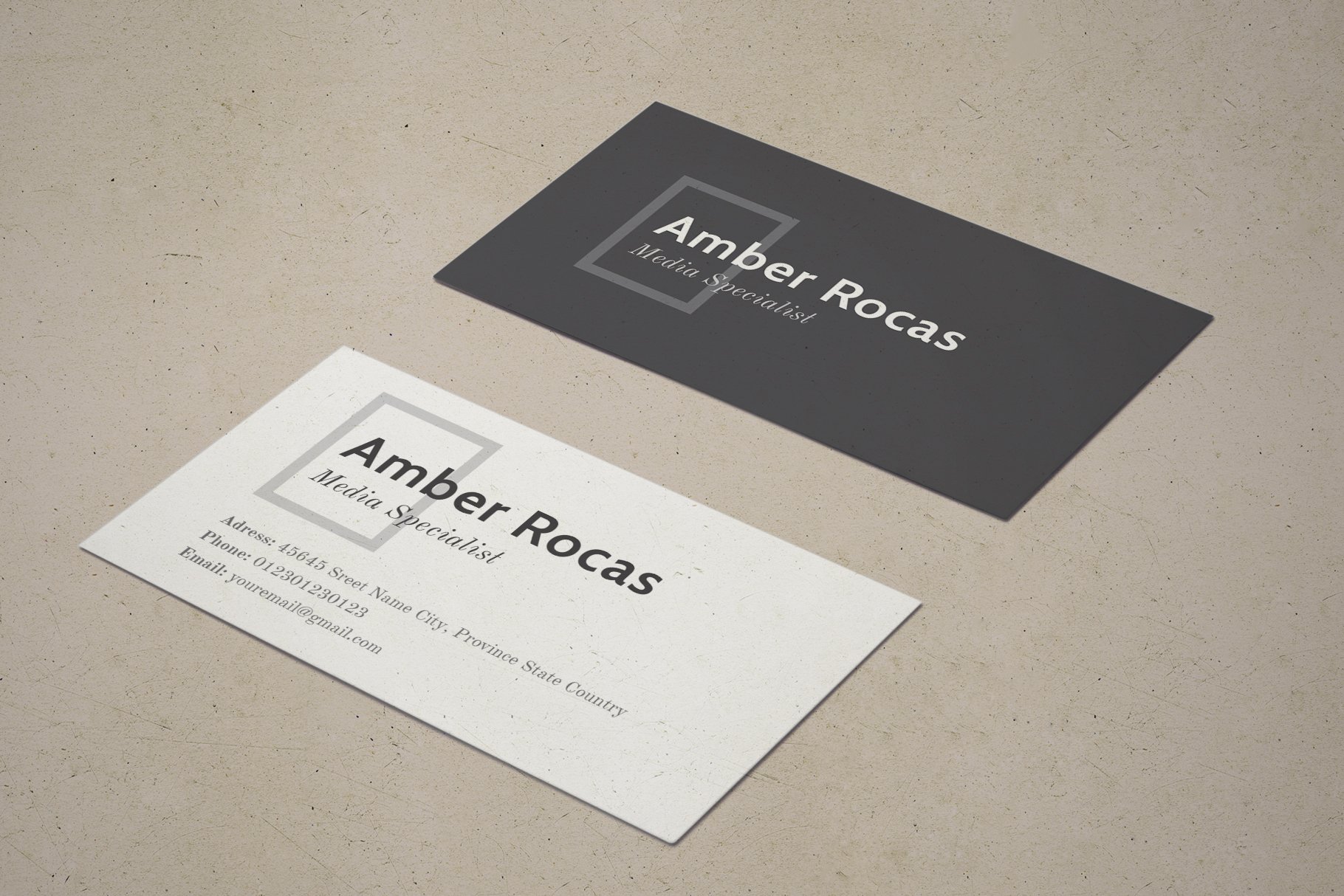 Close up of two business cards on a table.