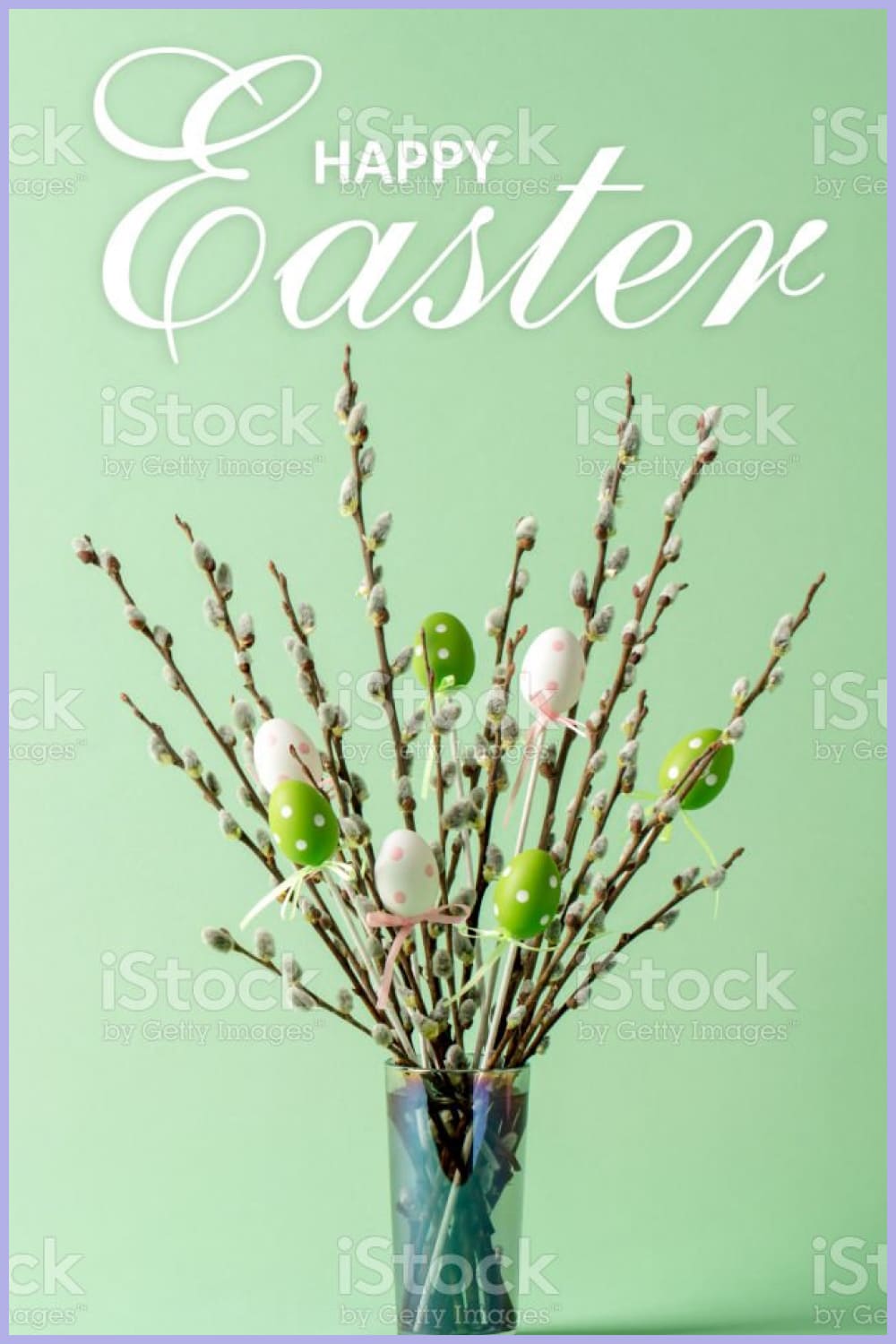 Easter eggs decorations and pussy willow twigs with catkins in a vase.
