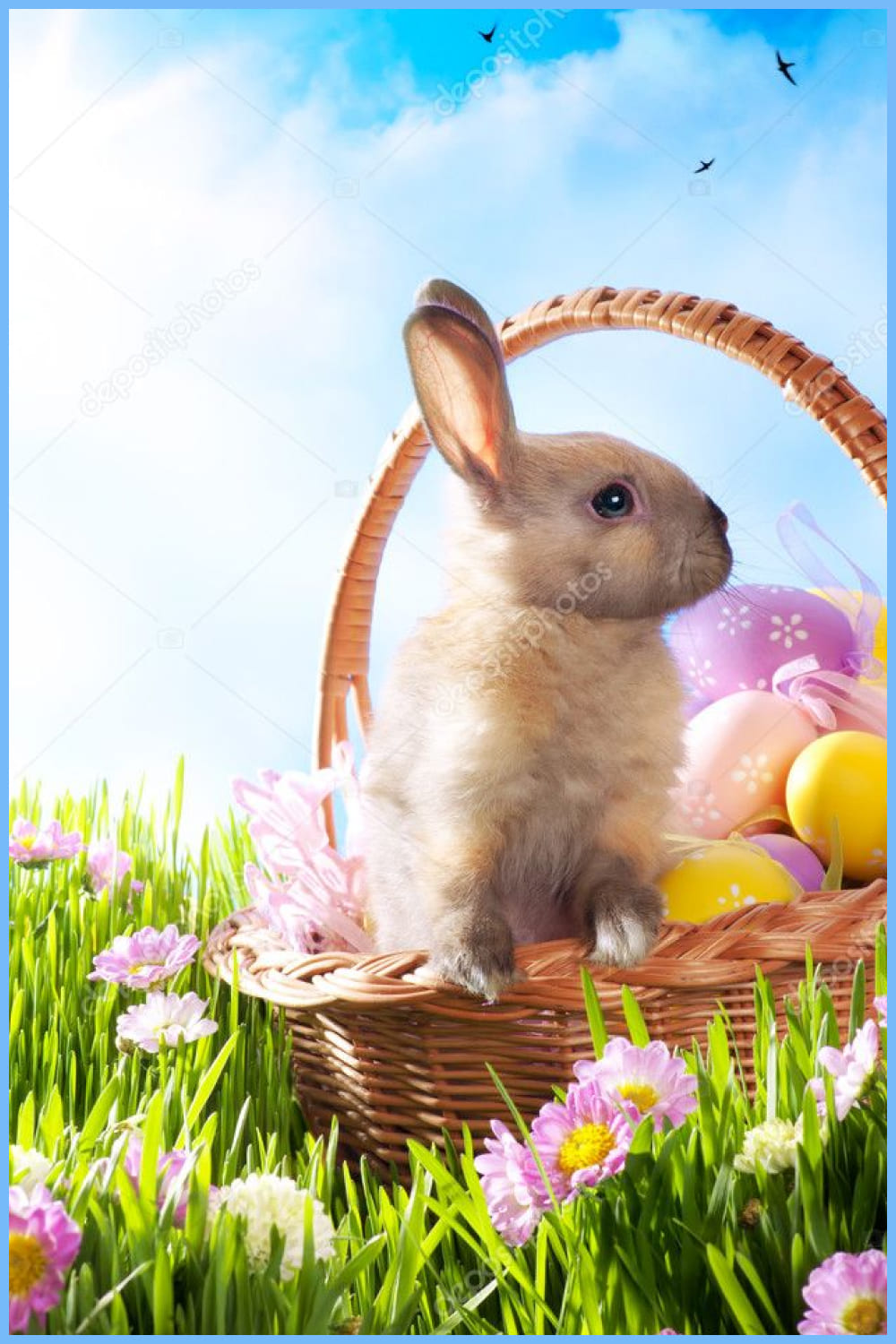 Easter basket with decorated eggs and the Easter bunny on the grass.