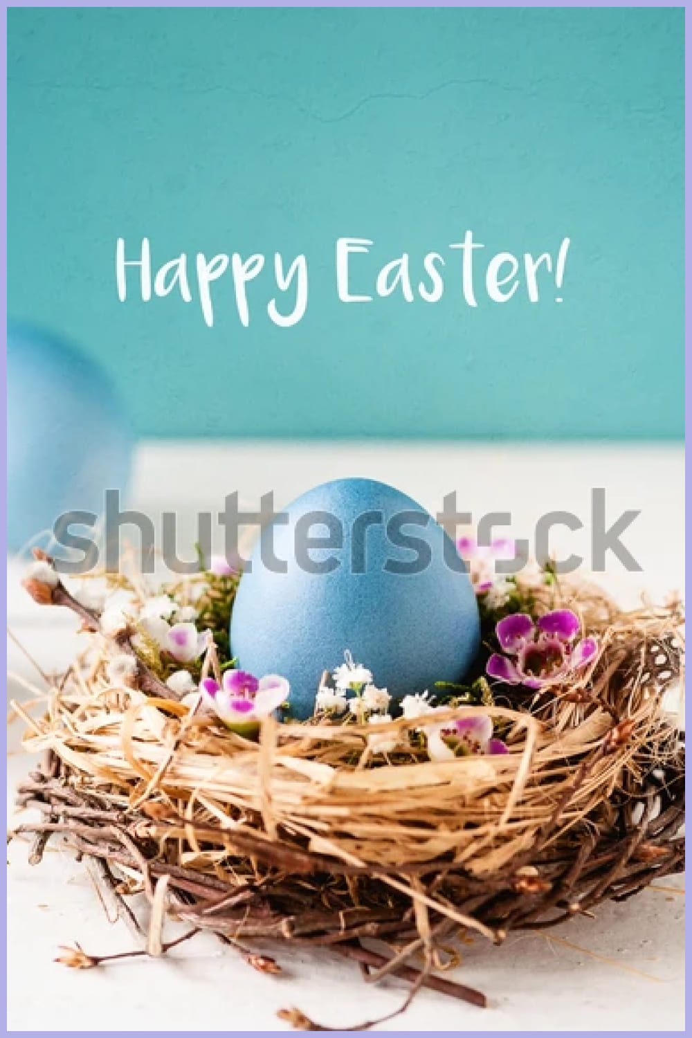blue egg in a nest of straw with flowers.