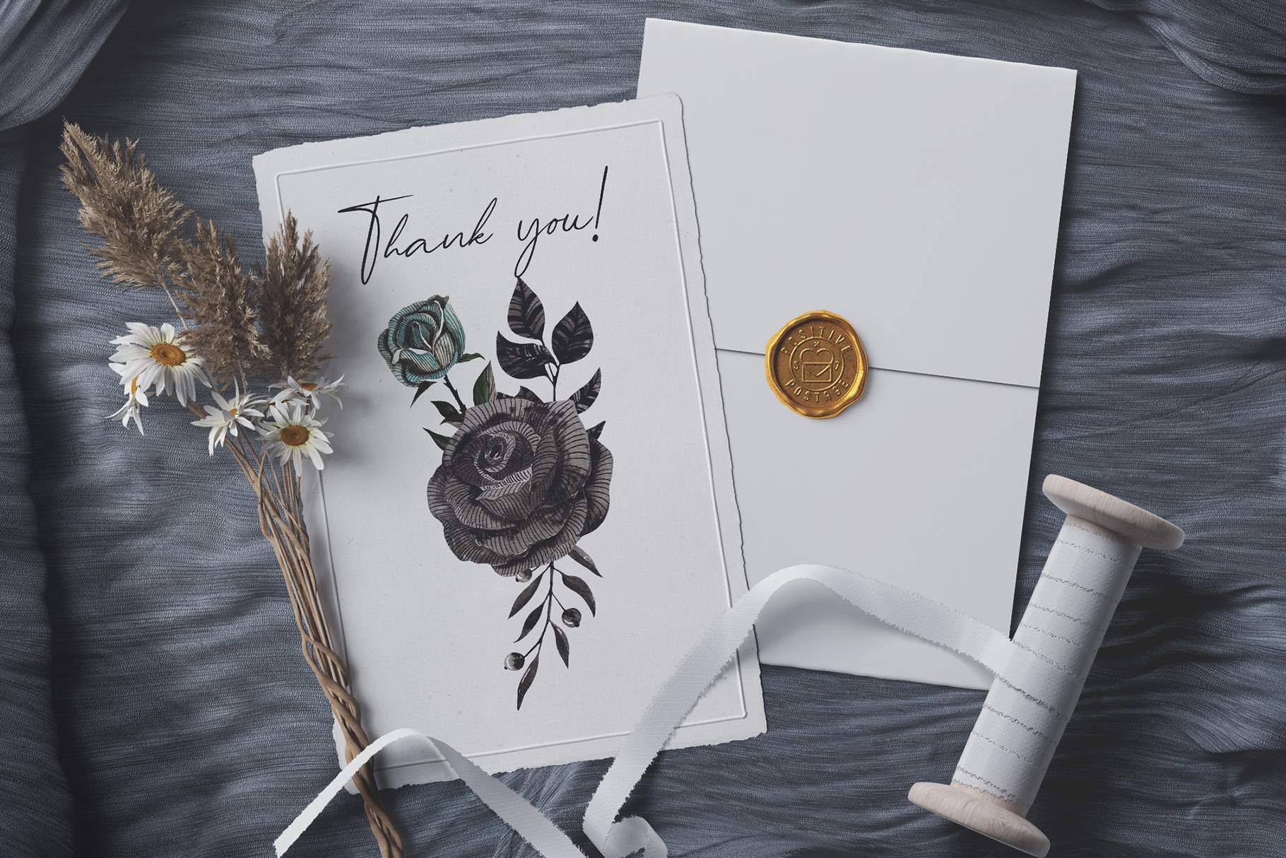 Thank you card with a flower and a spool of thread.