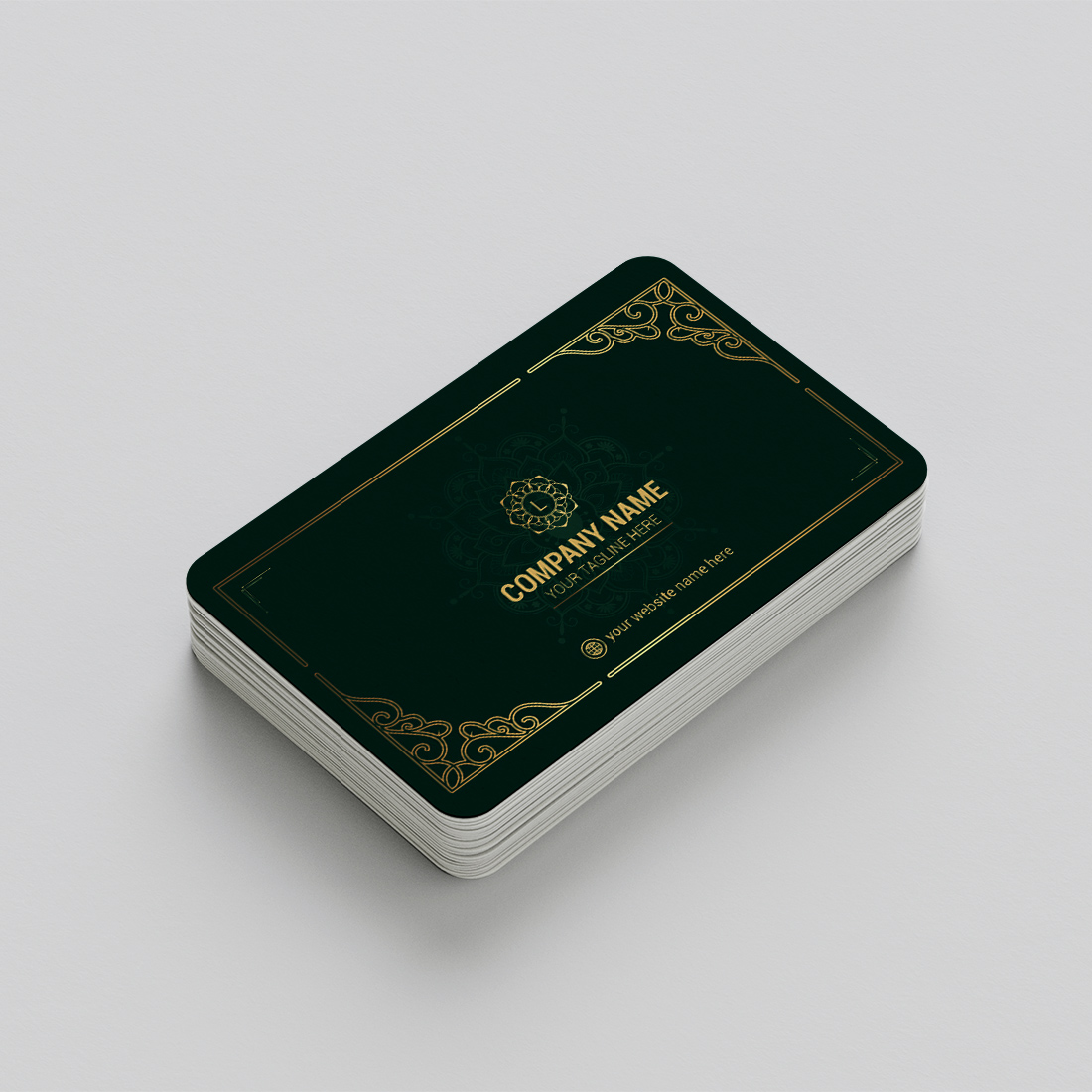 Green and gold business card on a white surface.