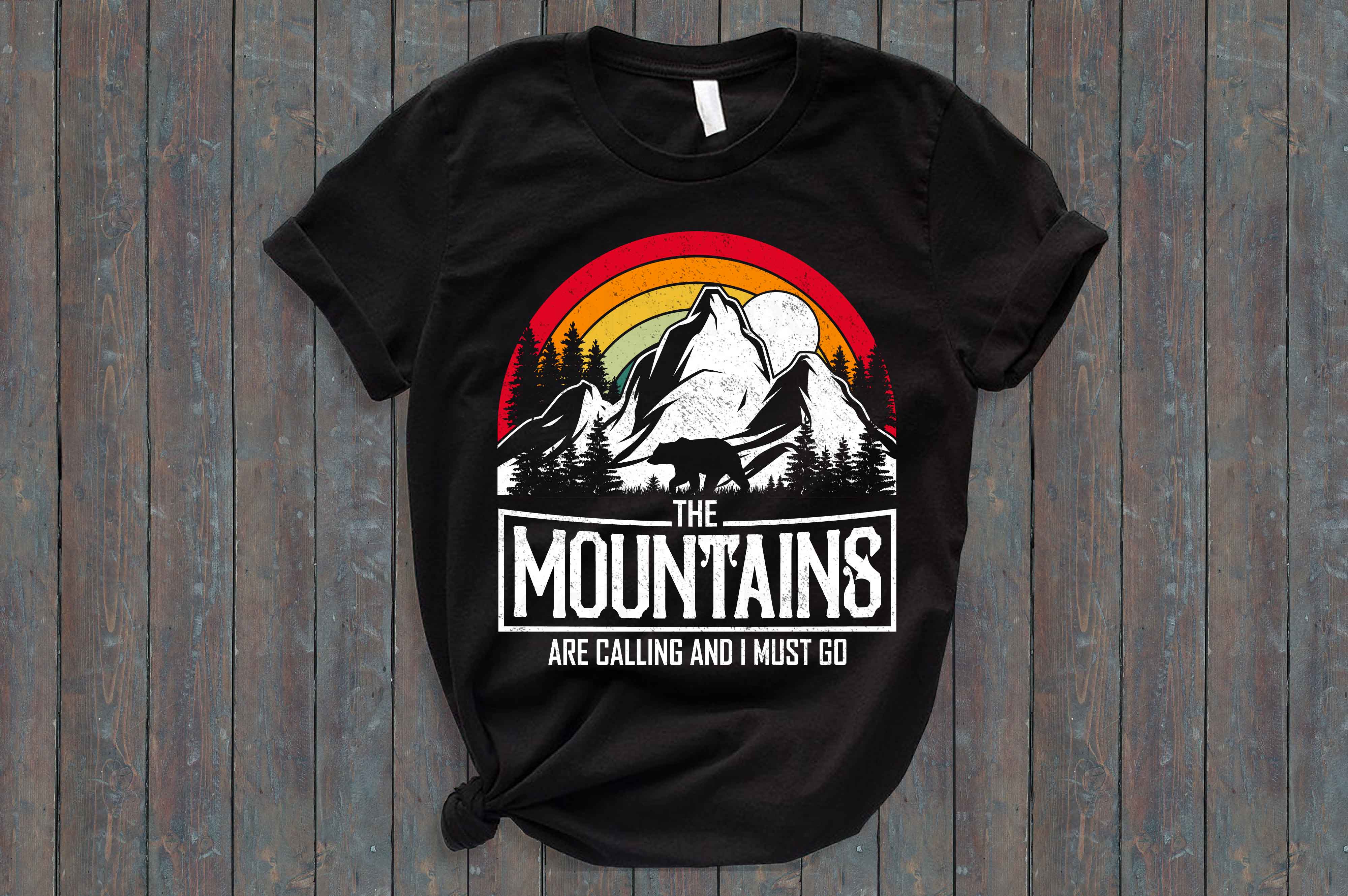 Black t - shirt that says the mountains are calling and must go.