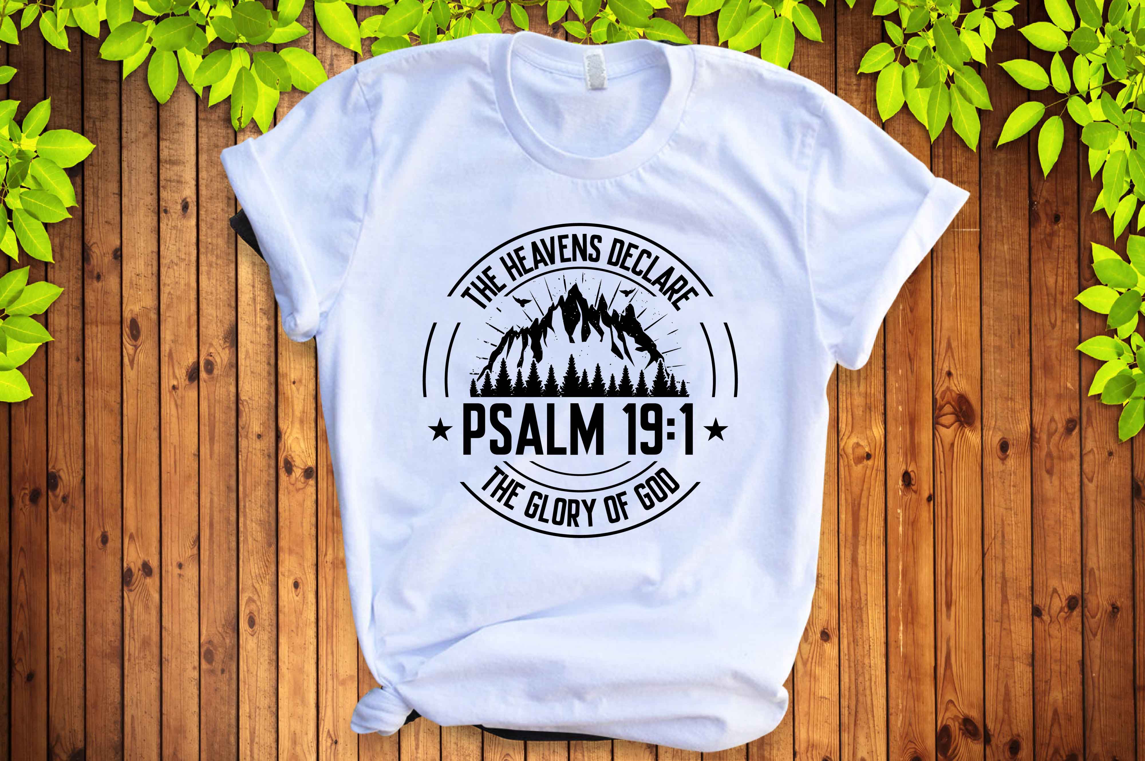 White t - shirt with a mountain scene and the words.
