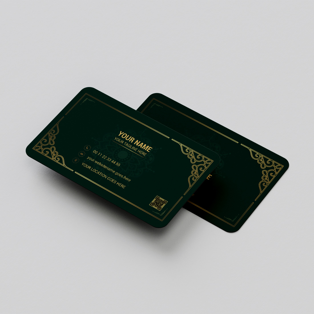 Pair of green business cards sitting on top of each other.