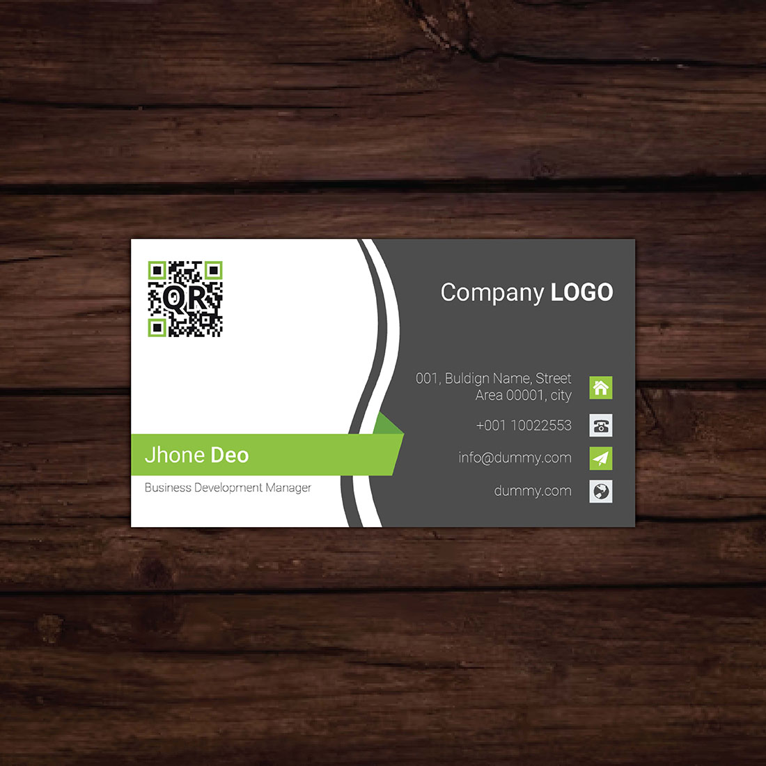 Close up of a business card on a wooden surface.