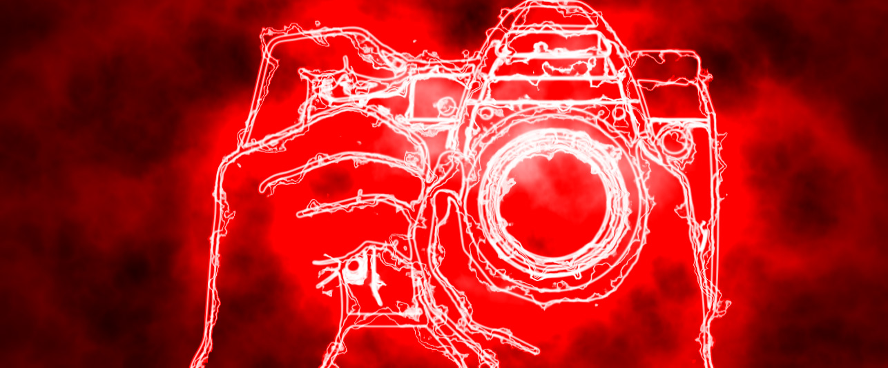 Digital camera with a red background.