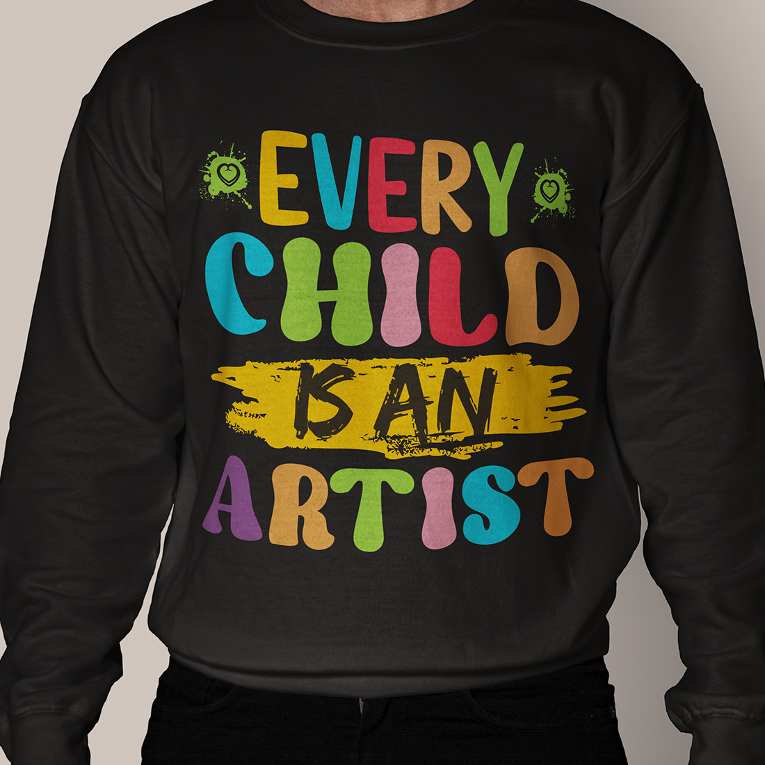 Man wearing a black sweatshirt with the words every child is an artist on it.