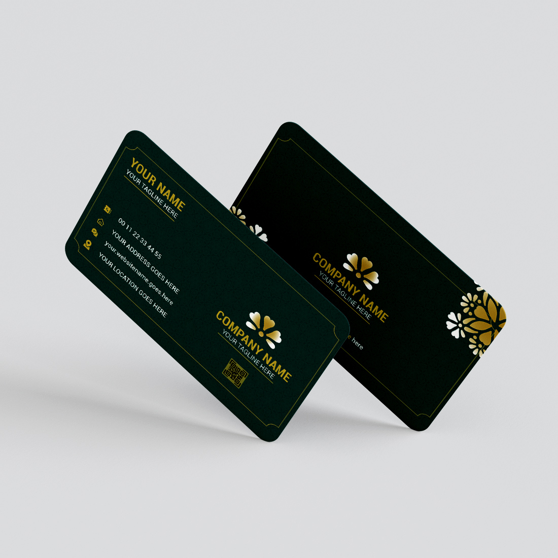 Two green business cards with gold flowers on them.