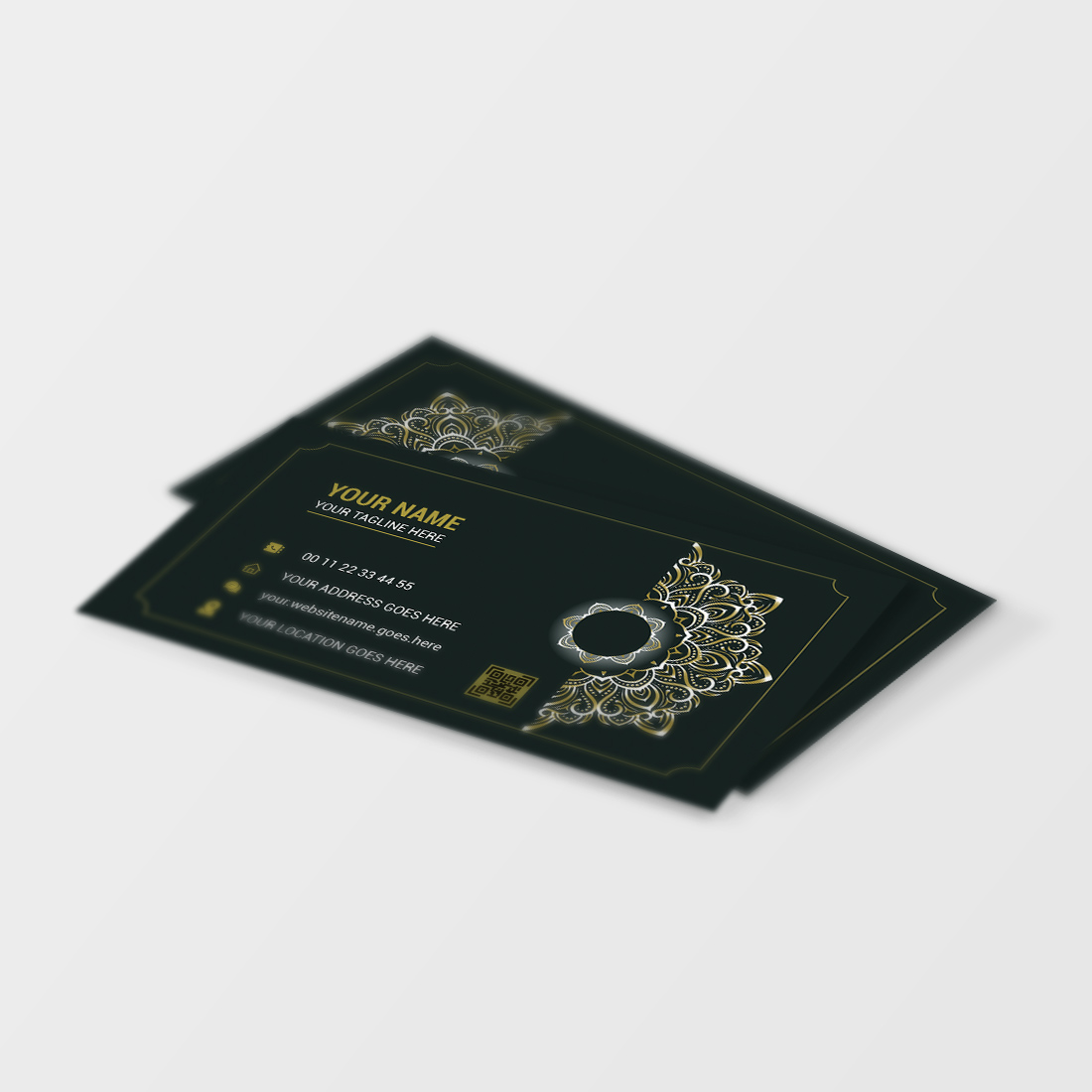 Black and gold business card on a white surface.