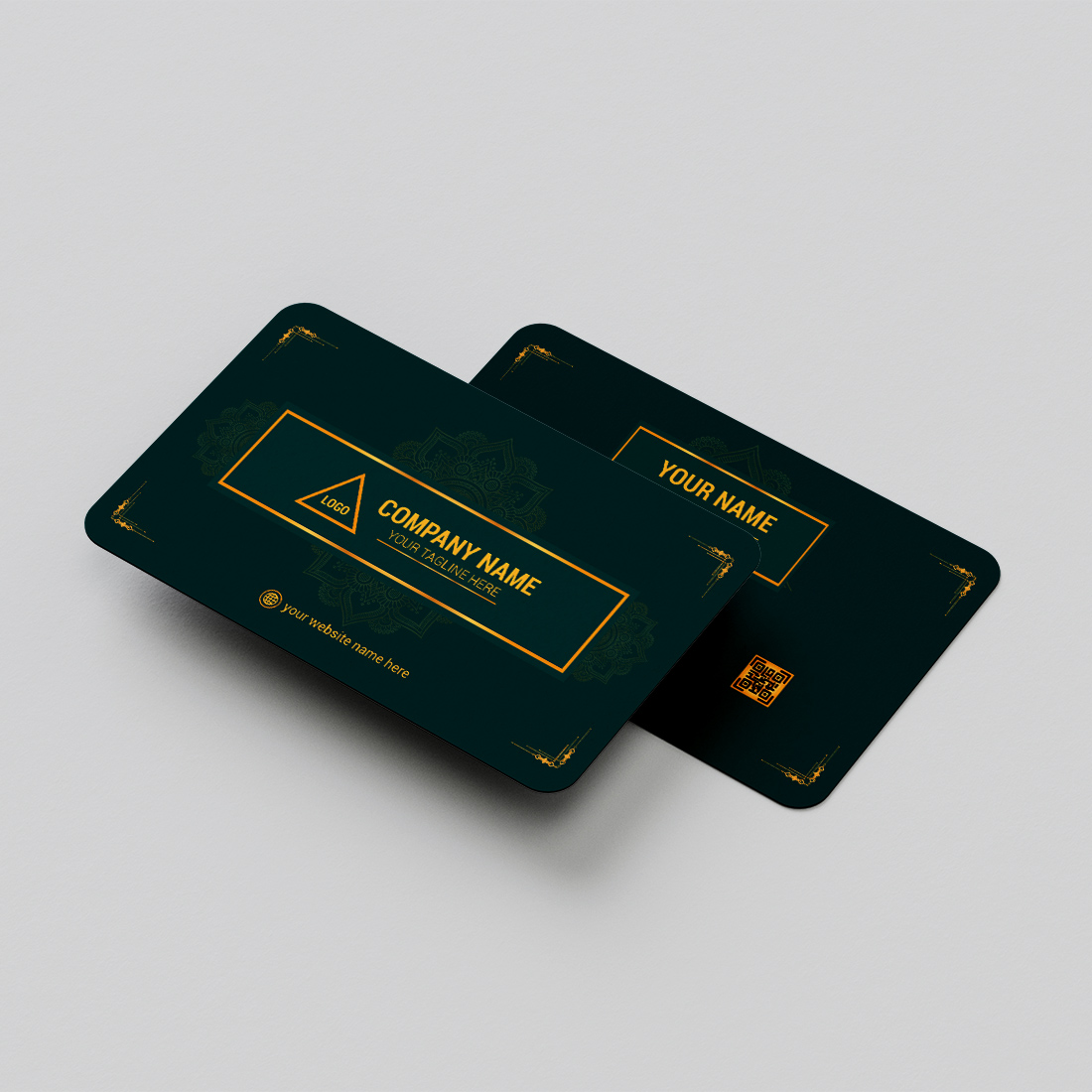 Two green credit cards sitting on top of each other.