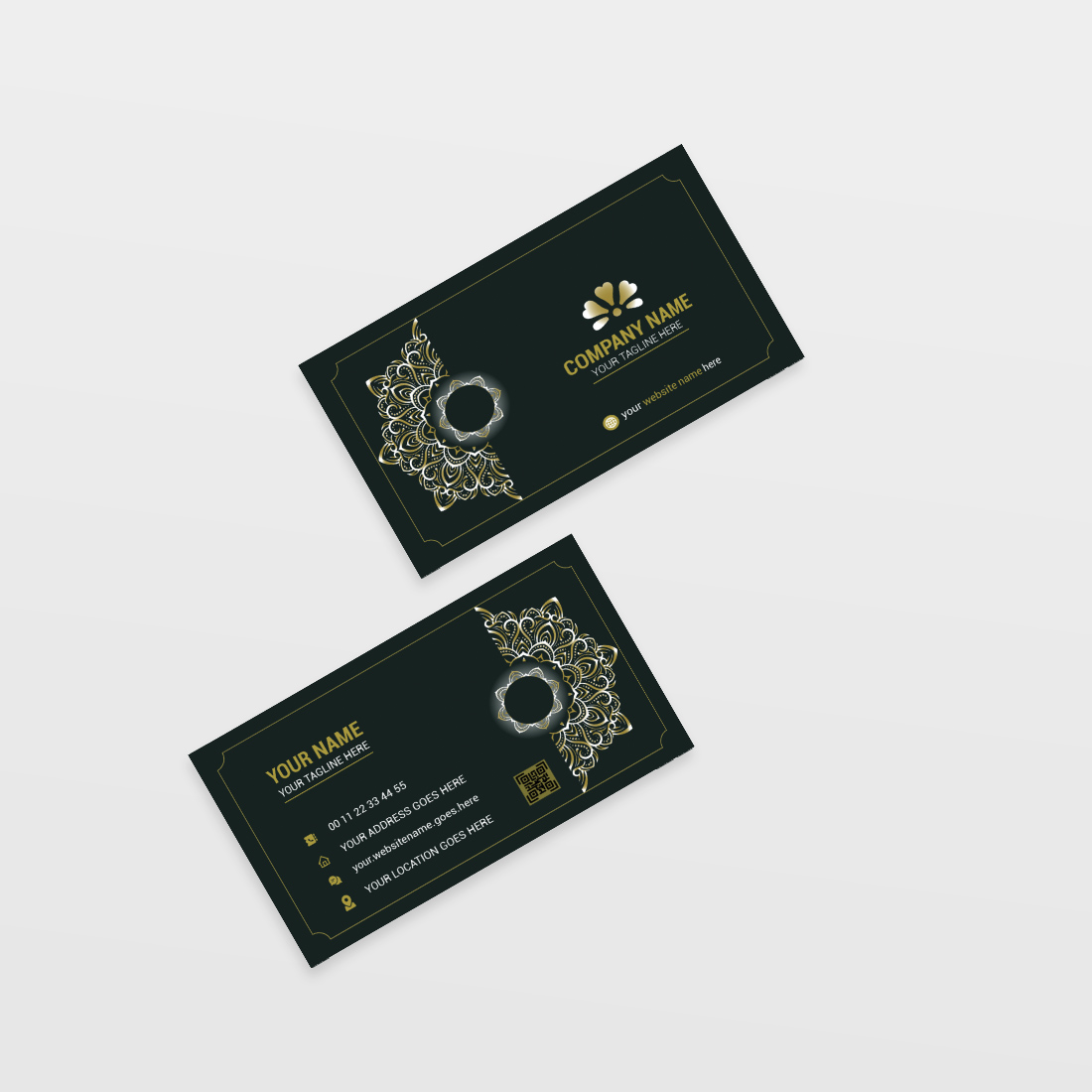 Two black and gold business cards on a white surface.