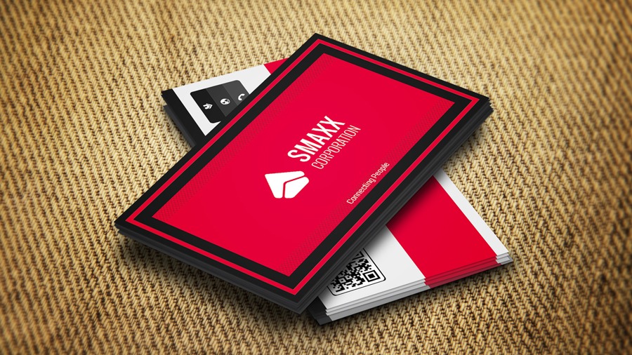 Two red and black business cards sitting on top of each other.