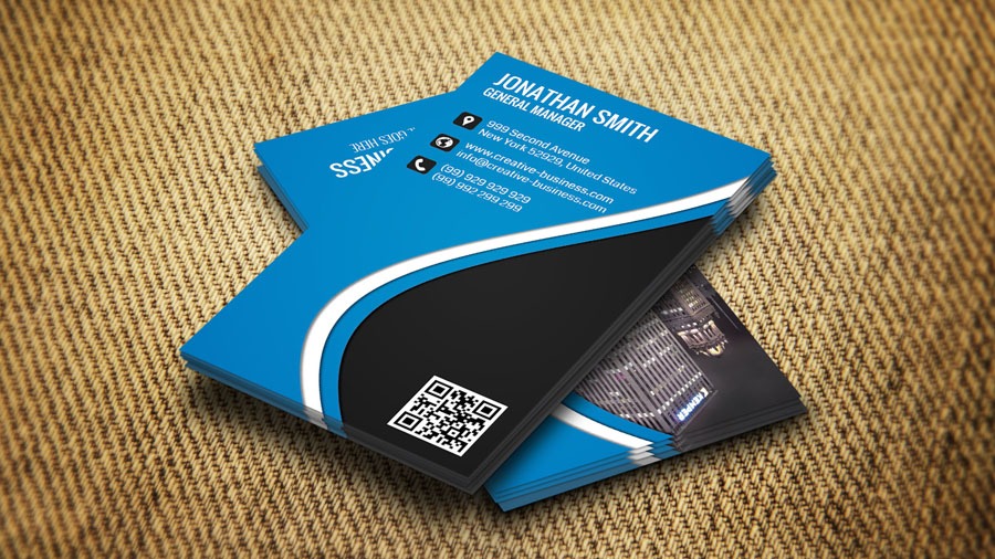 Blue and black business card sitting on top of a couch.