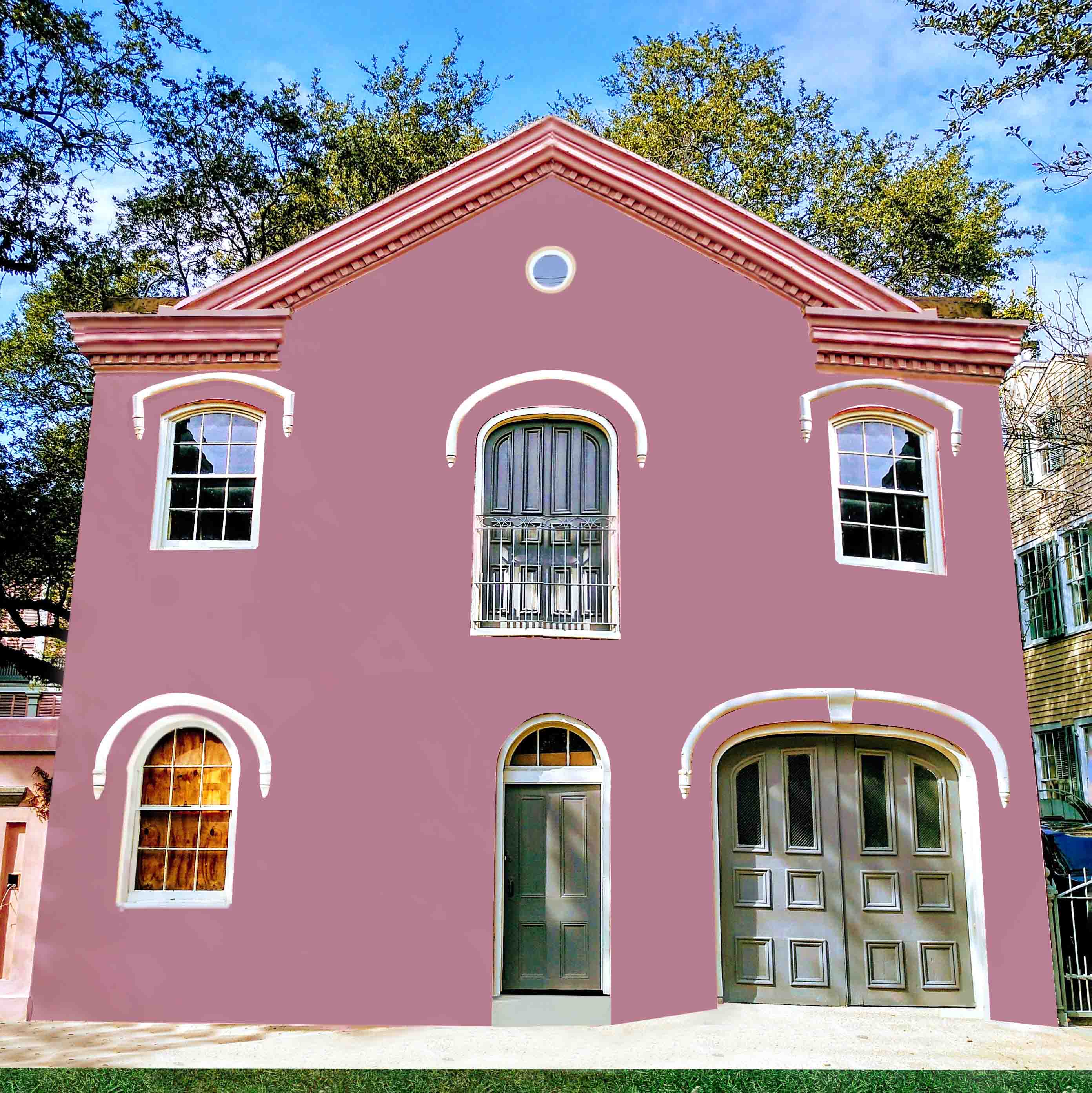 Pink house with two windows and a balcony.