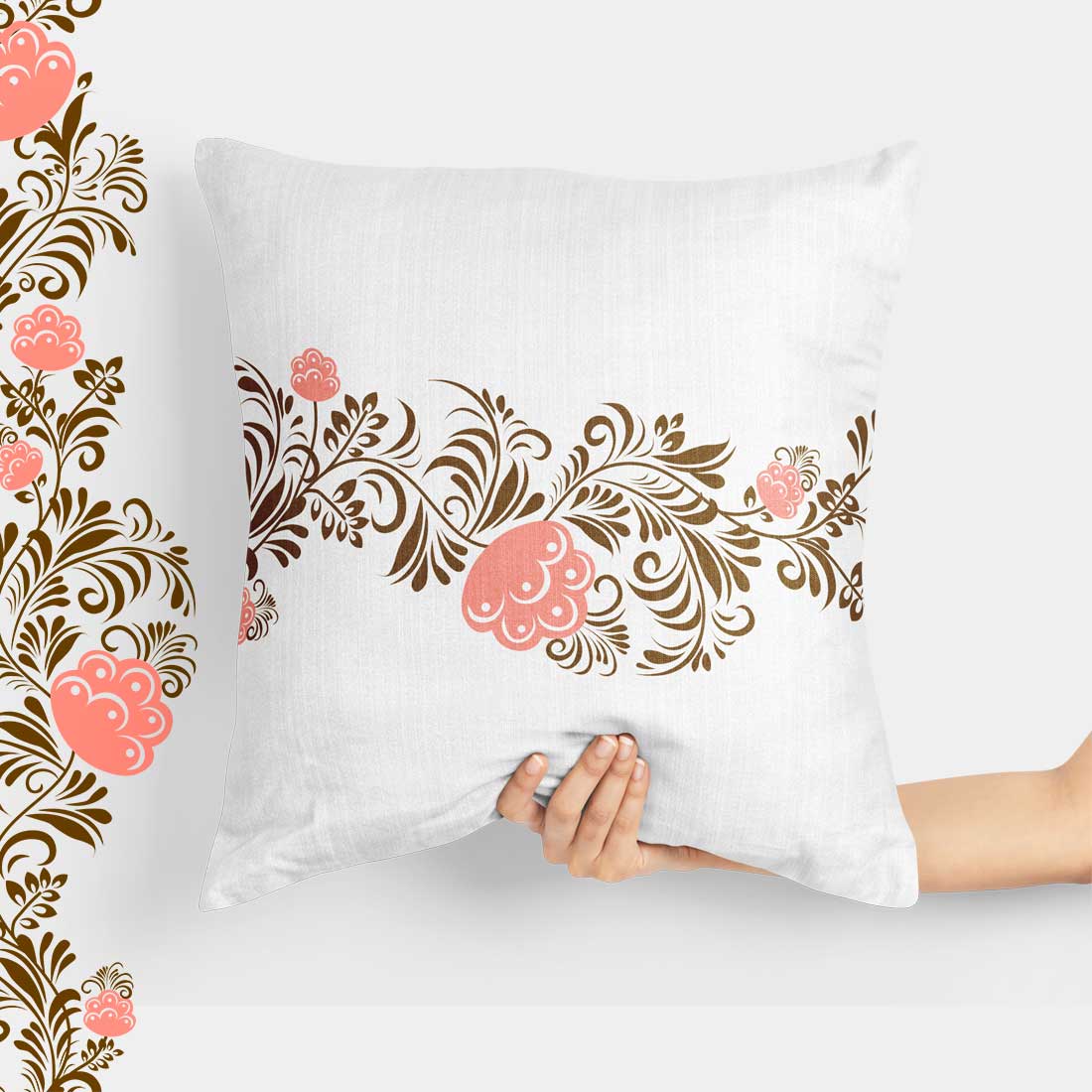 Person holding a pillow with a floral design on it.