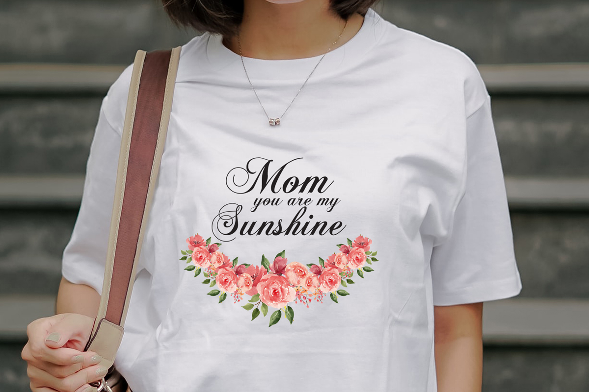 Woman wearing a mom you are my sunshine t - shirt.