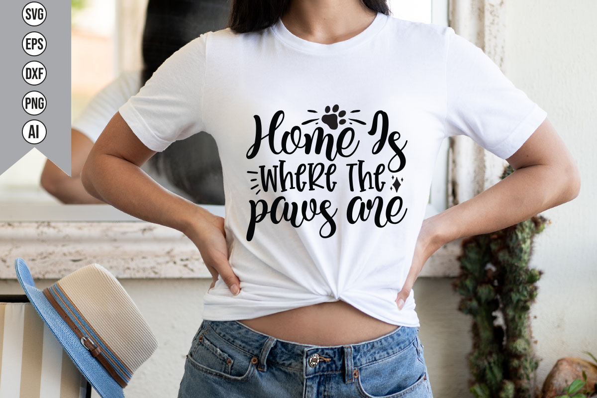 Woman wearing a t - shirt that says home is where the paws are.