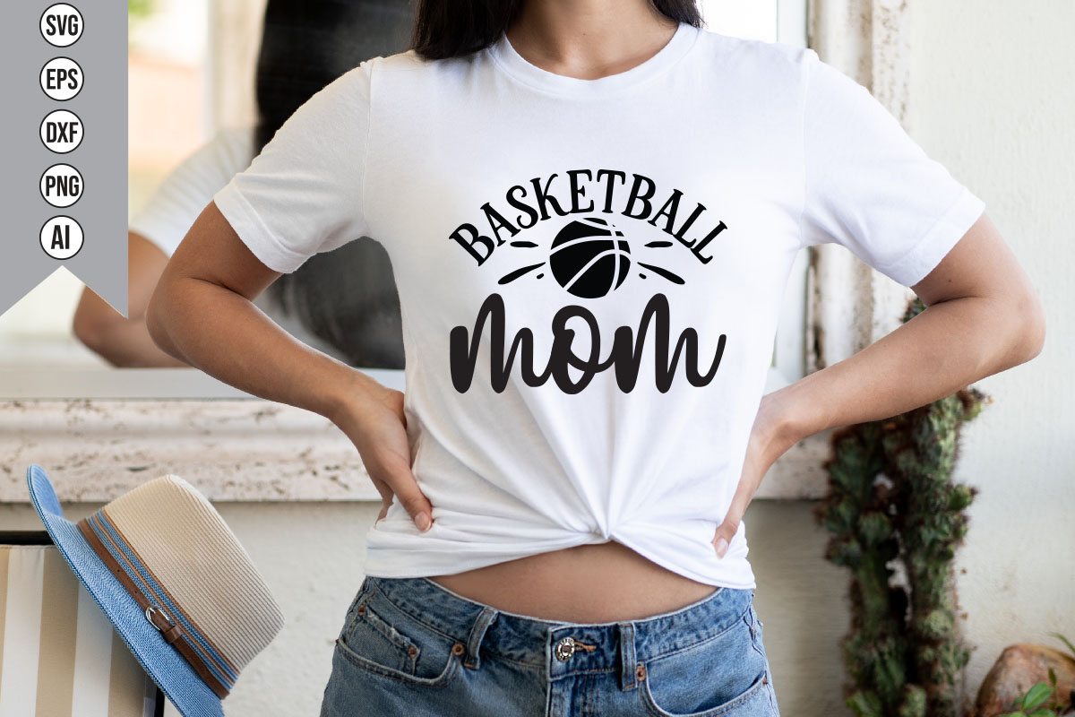 Woman wearing a white shirt with a basketball mom on it.