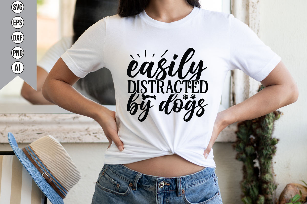Woman wearing a t - shirt that says easily distracted by dogs.