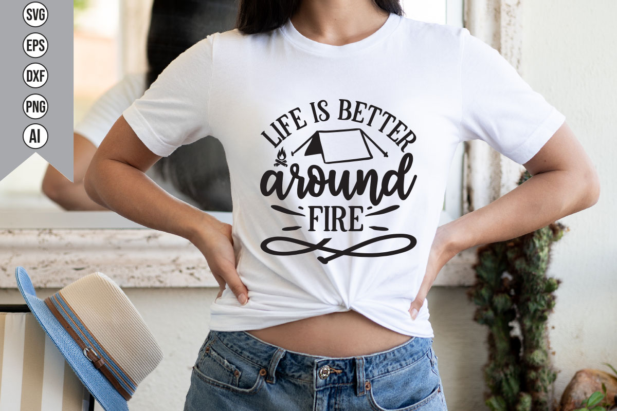 Woman wearing a t - shirt that says life is better around the fire.