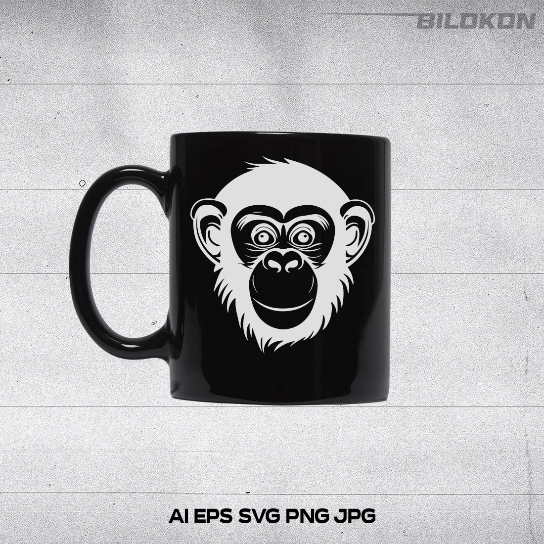 Black coffee mug with a monkey face on it.