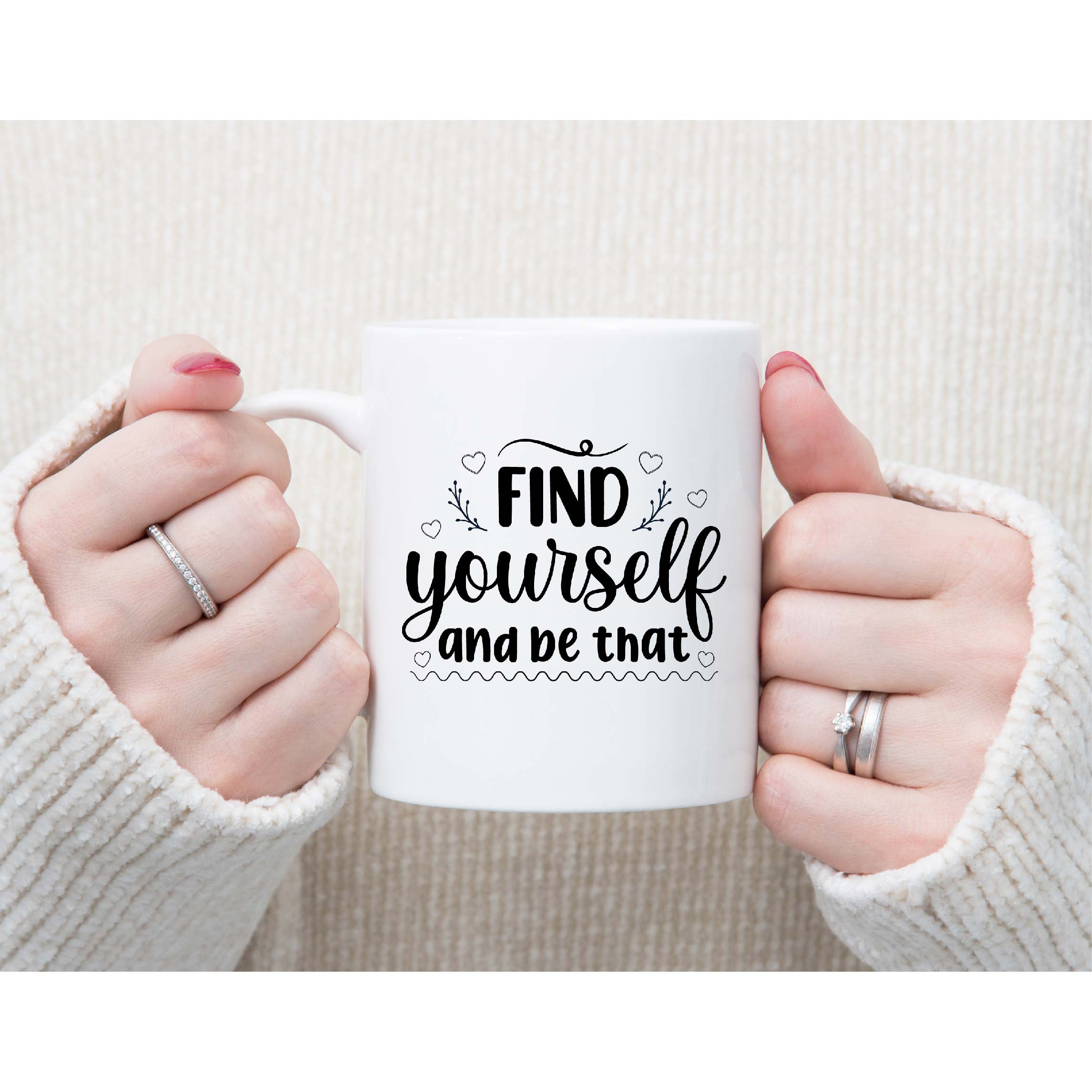 Woman holding a coffee mug with the words find yourself and be craft.